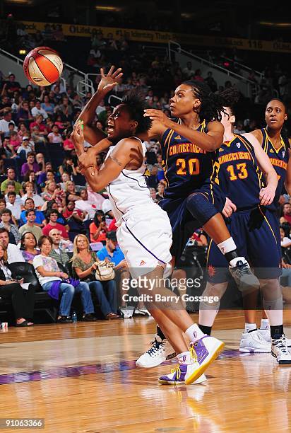 Cappie Pondexter of the Phoenix Mercury has the ball knocked loose by Tan White of the Connecticut Sun during the game on August 29, 2009 at U.S....
