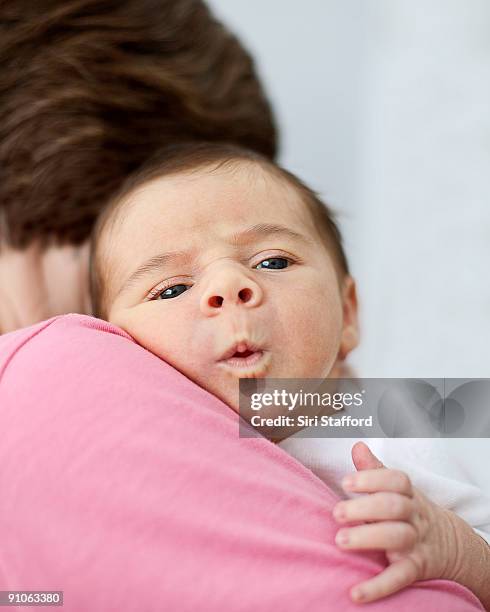 woman holding infant baby boy, puckering - siri stafford fotografías e imágenes de stock