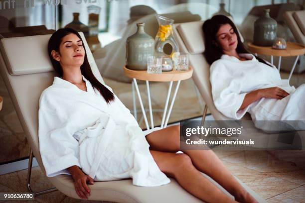 young women relaxing together in robes at luxurious spa - robe 2017 stock pictures, royalty-free photos & images