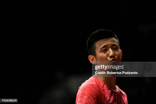Chen Long of China competes against Anthony Sinisuka Ginting of Indonesia during the Men's Singles Quarter Final match of the Daihatsu Indonesia...