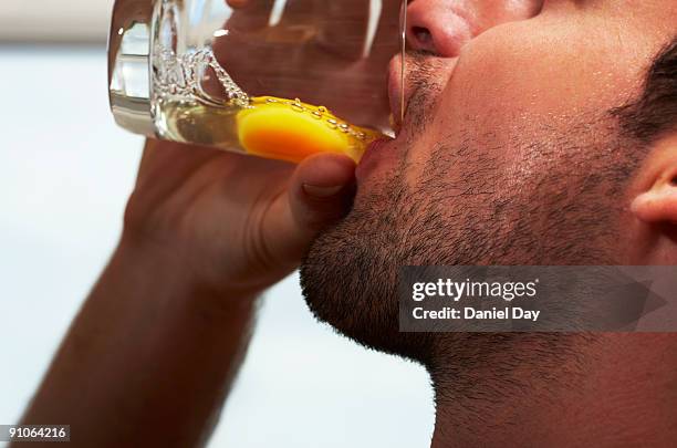 man drinking raw egg - dotter stock-fotos und bilder