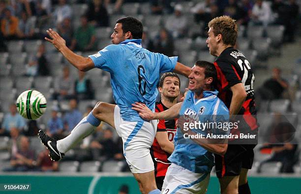 Mathieu Beda and Kenny Cooper of 1860 Munich tackle Arne Friedrich and Rasmus Bengtsson of Berlin during the DFB Cup second round match between TSV...