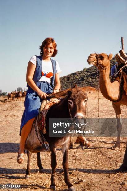 the seventies. a young woman enjoy her holiday in turkey by riding a donkey. - 1974 stock pictures, royalty-free photos & images