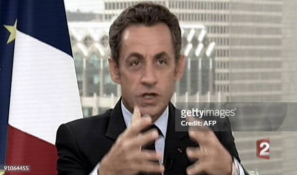 This Tv grab taken from French TV channel France 2 shows French president Nicolas Sarkozy answering to journalists Laurence Ferrari and David...