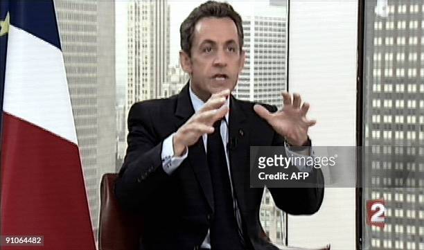 This Tv grab taken from French TV channel France 2 shows French president Nicolas Sarkozy answering to journalists Laurence Ferrari and David...