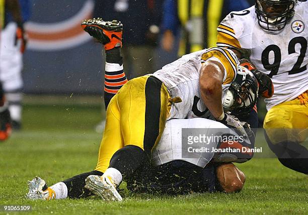 Greg Olsen of the Chicago Bears is upended by James Farrior of the Pittsburgh Steelers as teammate James Harrison moves in on September 20, 2009 at...