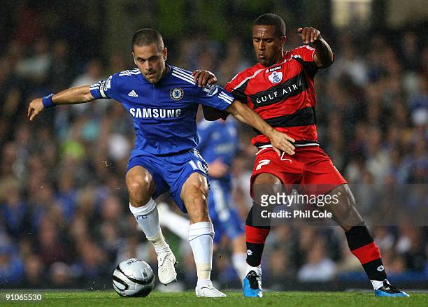 Joe Cole of Chelsea gets tackled by Wayne Routledge of Queens Park Rangers during the Carling Cup third round match between Chelsea and Queens Park...