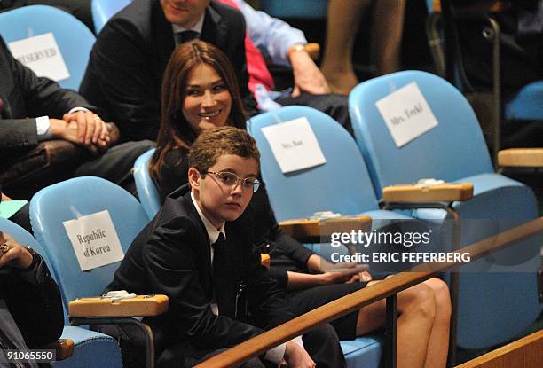 French First Lady Carla Bruni-Sarkozy and the President's son Louis Sarkozy applaud Nicolas Sarkozy at the end of his speech at the UN general...