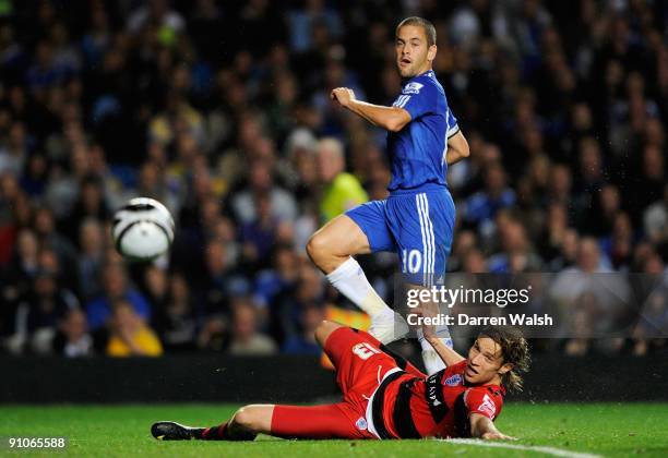 Joe Cole of Chelsea looks on as his shot goes wide under pressure from Kaspars Gorkss of QPR during the Carling Cup third round match between Chelsea...