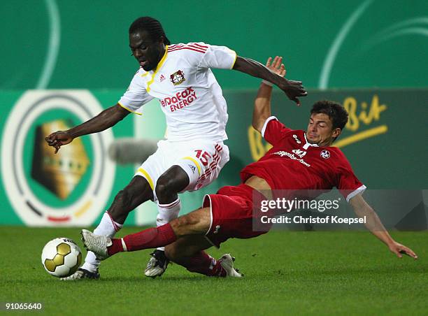 Dragan Paljic of Kaiserslautern tackles Hans Sarpei of Leverkusen during the DFB Cup second round match between 1. FC Kaiserslautern and Bayer...