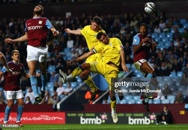 Anthony Gardner and Joe Ledley of Cardiff City head between Habib Beye and Carlos Cuellar of Aston Villa during the Carling Cup third round match...