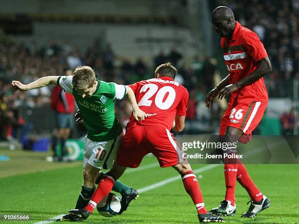 Marko Marin of Bremen and Matthias Lehmann of St. Pauli battle for the ball during the DFB Cup second round match between SV Werder Bremen and FC St....