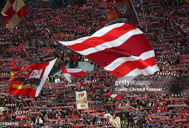 The fans of Lautern wave flags prior to the DFB Cup second round match between 1. FC Kaiserslautern and Bayer Leverkusen at Fritz-Walter-Stadion on...