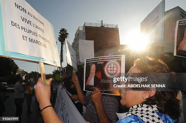 Militants of the Moroccan Association for Human Rights hold placards as they stage a demonstration in front of the French embassy in Rabat on...