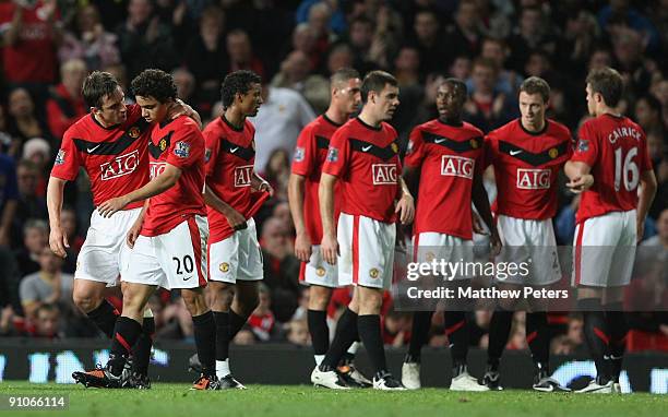 Fabio Da Silva of Manchester United is consoled by Gary Neville after being sent off during the Carling Cup Third Round match between Manchester...