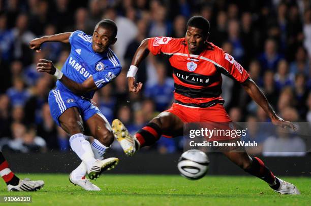 Salomon Kalou of Chelsea shoots past Mikele Leigertwood of QPR to score the opening goal during the Carling Cup third round match between Chelsea and...