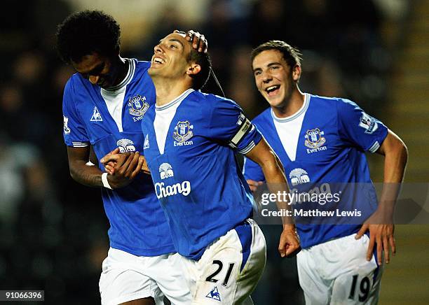 Leon Osman of Everton is congratulated on his goal by Jo and Dan Gosling during the Carling Cup Third Round match between Hull City and Everton at...