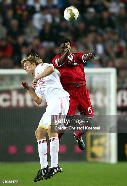 Stefan Kiessling of Leverkusen and Georges Mandjeck of Kaiserslautern jump for a header during the DFB Cup second round match between 1. FC...