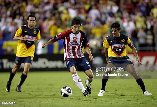 Jonny Magalon of Chivas de Guadalajara plays the ball as Pavel Pardo of Club América looks to defend the play during the Mexican First Division...