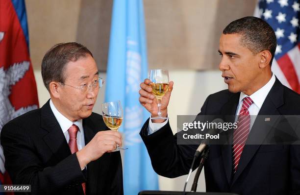 President Barack Obama makes a toast with United Nations Secretary General Ban Ki-moon at a luncheon during the United Nations General Assembly at UN...