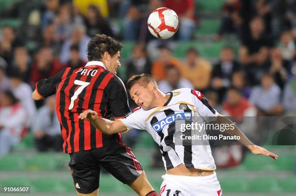 Andrea Coda of Udinese Calcio competes in the air with Pato of AC Milan during the Serie A match between Udinese Calcio and AC Milan at Stadio Friuli...