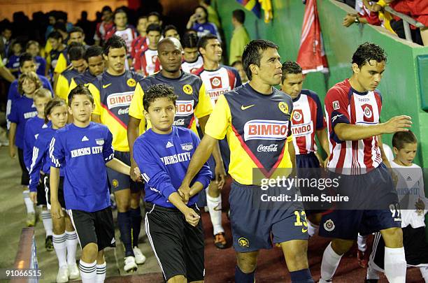 Pavel Pardo of Club América and Omar Bravo of Chivas de Guadalajara lead their respective teams to the field prior to their Mexican First Division...