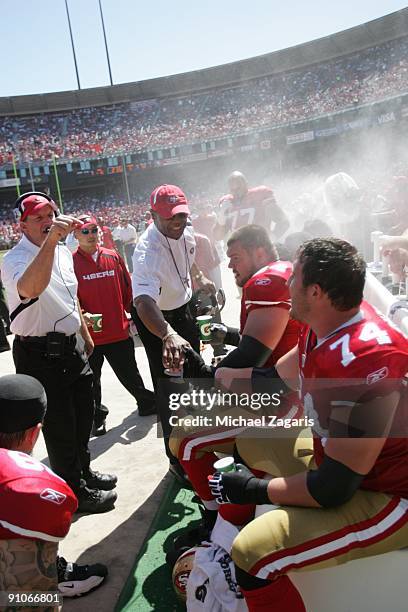 Head coach Mike Singletary of the San Francisco 49ers congratulates Joe Staley on the sideline during the NFL game against the Seattle Seahawks at...