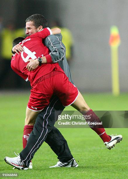 Bastian Schulz of Kaiserslautern celebrates the 2-1 victory with head coach Marco Kurz after the DFB Cup second round match between 1. FC...