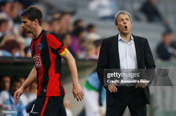 Team coach of Berlin Lucien Favre reacts as team captain Arne Friedrich passes by during the DFB Cup second round match between TSV 1860 Muenchen and...