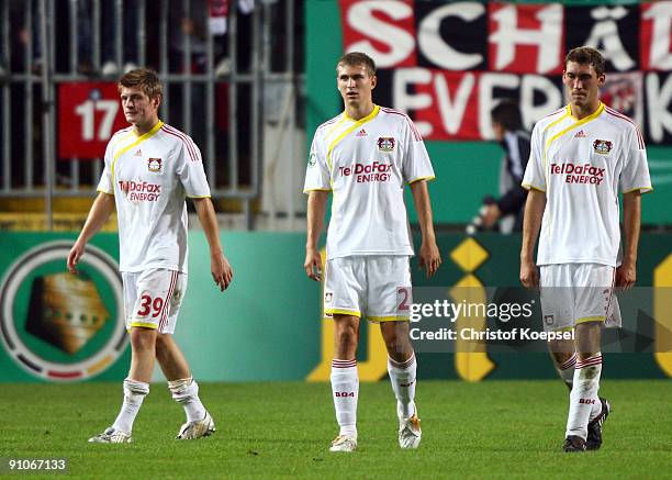 Toni Kroos, Daniel Schwaab and Stefan Reinartz of Leverkusen look dejected after losing 1-2 the DFB Cup second round match between 1. FC...