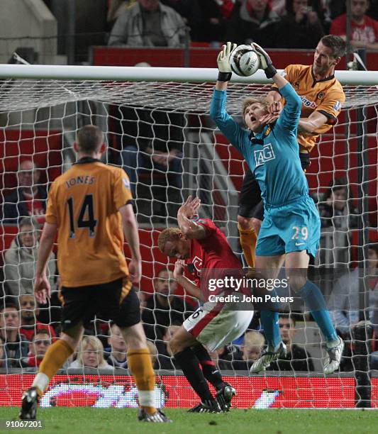 Tomasz Kuszczak of Manchester United clashes with Stefan Maierhofer of Wolverhampton Wanderers during the Carling Cup Third Round match between...
