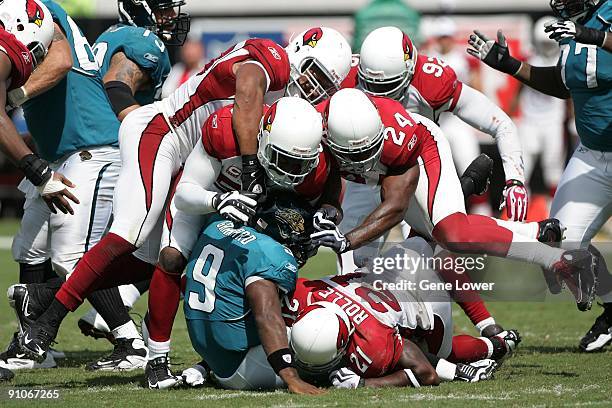 Arizona Cardinals defensive players Antrel Rolle, Karlos Dansby and Adrian Wilson converge for a sack during a game against the Jacksonville Jaguars...