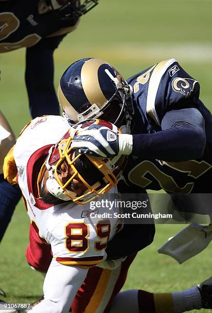 SAntana Moss of the Washington Redskins is tackled by Oshiomogho Atogwe of the St. Louis Rams at FedEx Field on September 20, 2009 in Landover,...