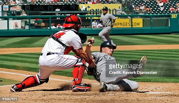 Mark Teixeira of the New York Yankees is tagged out at home plate by catcher Mike Napoli of the Los Angeles Angels of Anaheim on a throw from left...