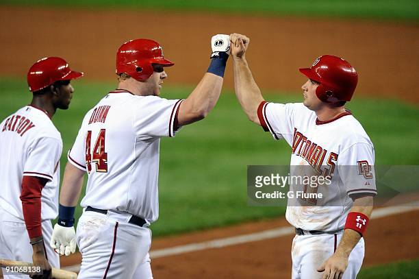 Adam Dunn of the Washington Nationals is congratulated by Ryan Zimmerman after hitting a home run against the Los Angeles Dodgers at Nationals Park...