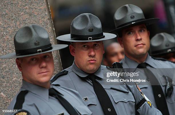 Group of state troopers watch over a small group of protesters denouncing globalization in downtown Pittsburgh the day before the G-20 Summit...