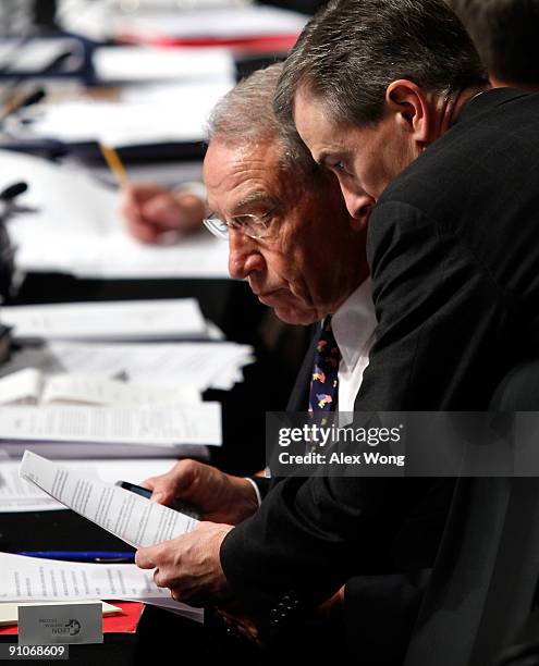 Sen. Chuck Grassley listens to an aide during a mark up hearing before the U.S. Senate Finance Committee on Capitol Hill September 23, 2009 in...