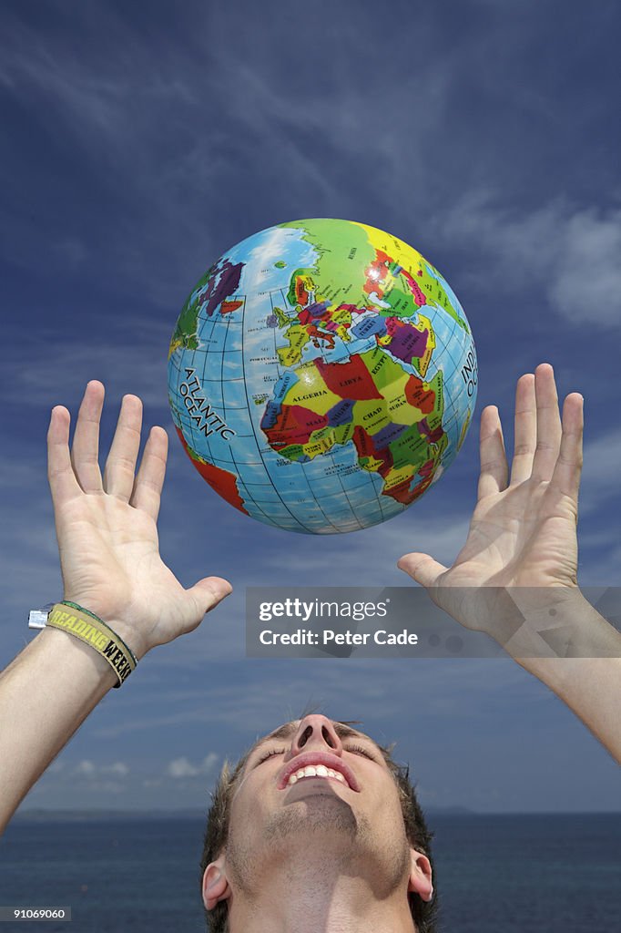Man throwing globe