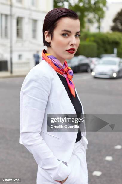 woman standing in street wearing short white linen jacket - silk scarves stock pictures, royalty-free photos & images