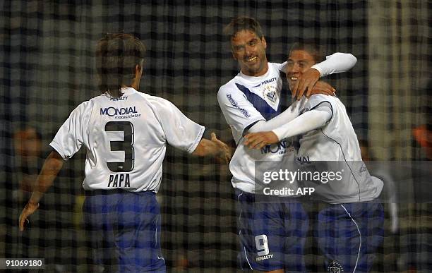 Argentina's Velez Sarsfield forward Hernan Lopez celebrates with his teammates Jonathan Cristaldo and Emiliano Papa after scoring a goal against...