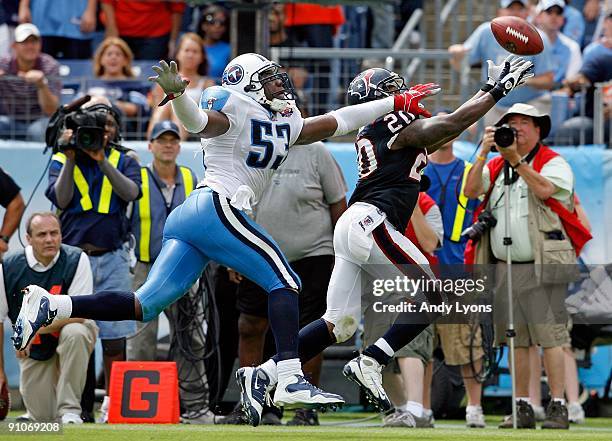 Steve Slaton of the Houston Texans reaches for a pass while defended by Keith Bulluck of the Tennessee Titans during the NFL game at LP Field on...