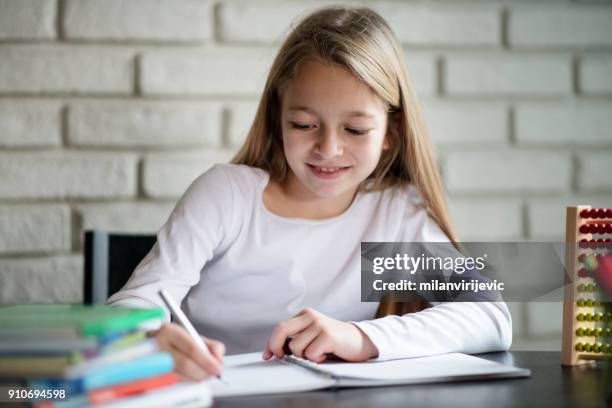 beautiful schoolgirl doing homework - 6 year old blonde girl stock pictures, royalty-free photos & images