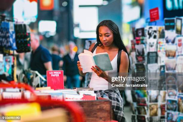 woman buying books - pop up store stock pictures, royalty-free photos & images