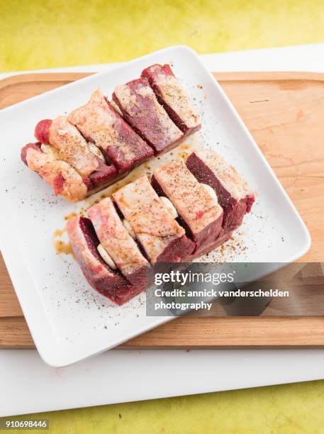 chuck beef with slivers of garlic having been rolled in soy sauce. - schmorbraten stock-fotos und bilder