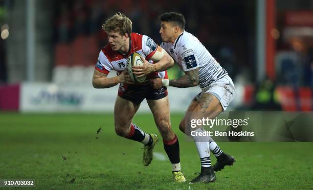 Ollie Thorley of Gloucester is tackled by Jay Baker of Ospreys during the Anglo-Welsh Cup match between Gloucester Rugby and Ospreys at Kingsholm...