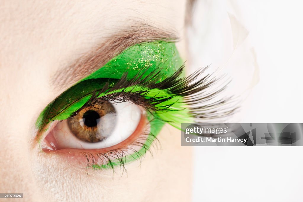 Close-up of eye with green make-up.