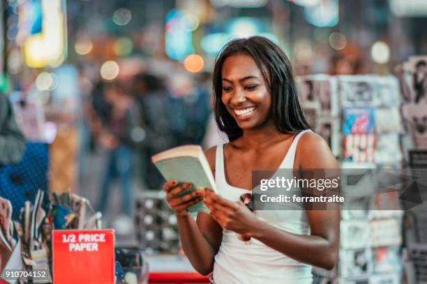 woman buying books - times square store stock pictures, royalty-free photos & images