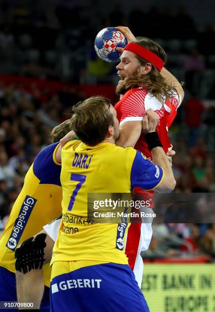 Mikkel Hansen of Denmark challenges Max Darj of Sweden during the Men's Handball European Championship semi final match between Denmark and Sweden at...