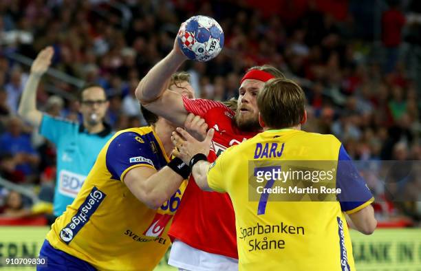 Mikkel Hansen of Denmark challenges Max Darj of Sweden during the Men's Handball European Championship semi final match between Denmark and Sweden at...