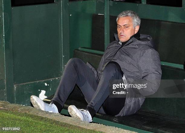 Manchester United's Portuguese manager Jose Mourinho sits in the dugout ahead of the FA Cup fourth round football match between Yeovil Town and...